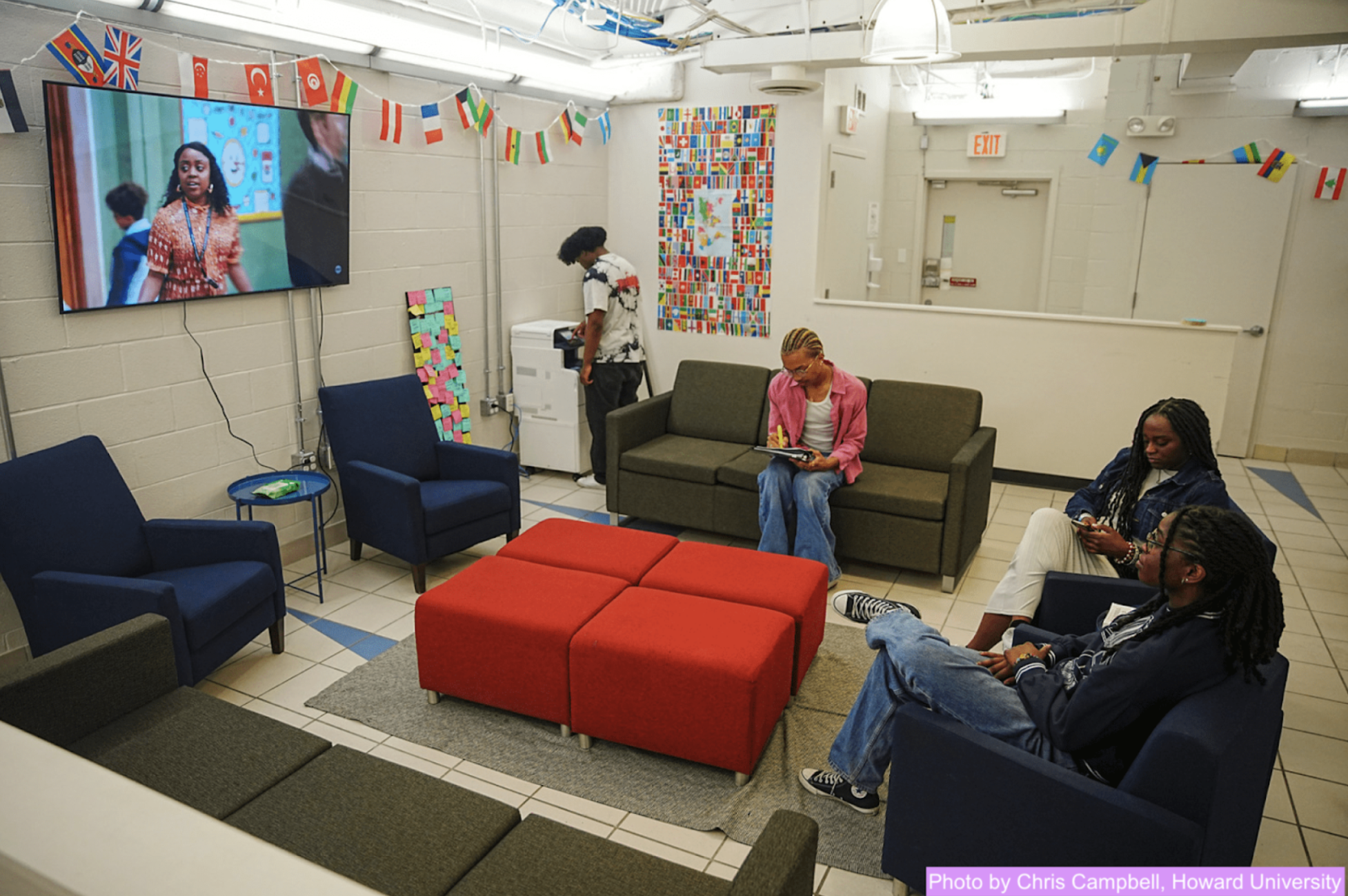 Four Black students in a recreation room at Howard University watching Abbott Elementary